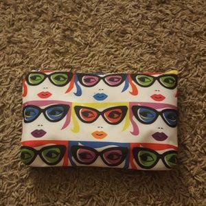 Makeup bag with faces on it